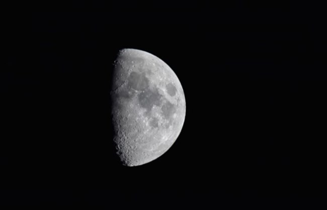 a view of the moon in the darkness