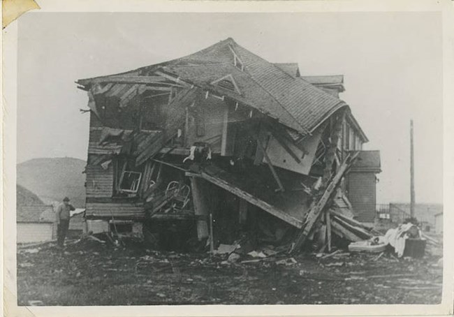 a historic scene of a two-story building in total wreckage.