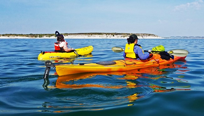 Two people kayaking in the reservoir's clear waters.