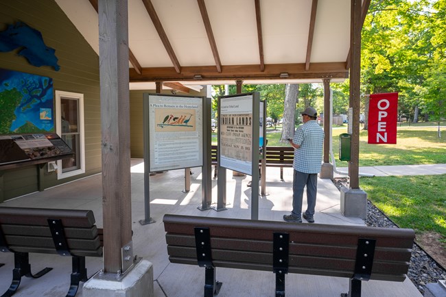 Photograph of exhibits under slanted roof at Little Sand Bay visitor center.