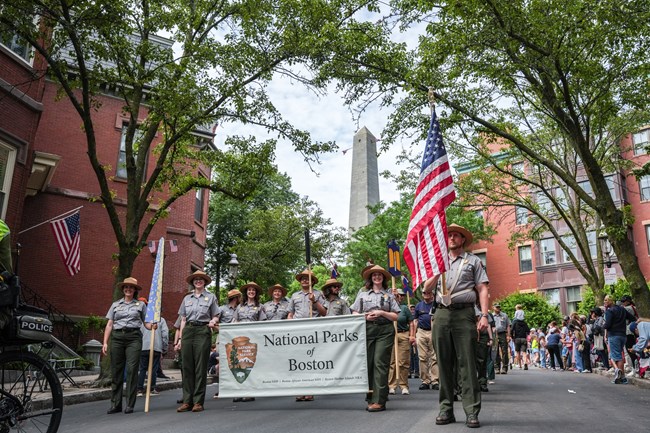 2025.06.15_BOST_Parade-131 NPS uniformed rangers and volunters march with the Bunker Hill Monument in the background