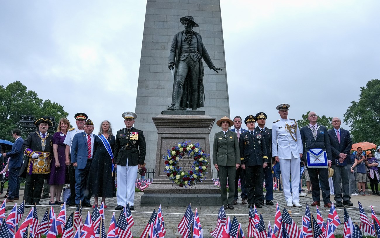 2025.06.17_BOST_Bunker Hill_NPS_CGould-177 dignitaries in suits or uniforms around the William Prescott statue with a wreath