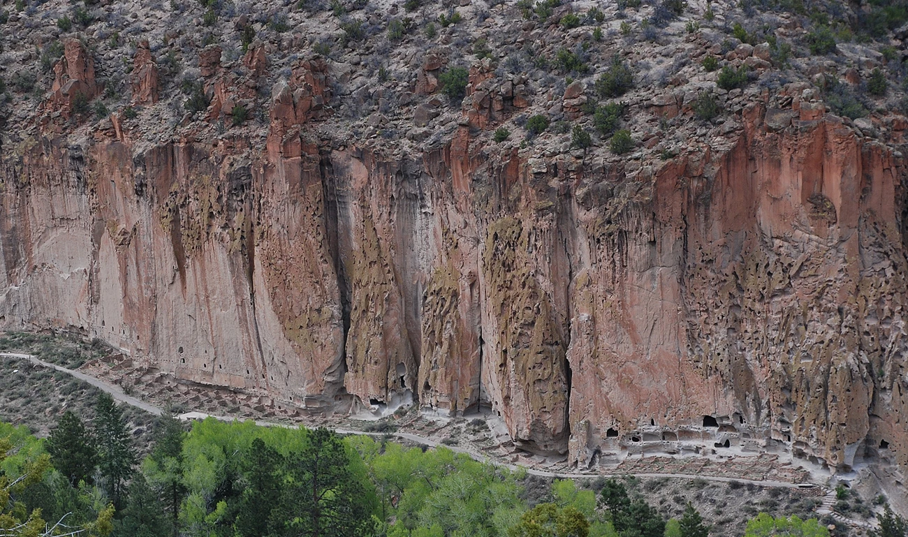 4748547747_c22095c143_o-cropped Photo of a tall cliff with windows and doors carved in to the rock at the base.