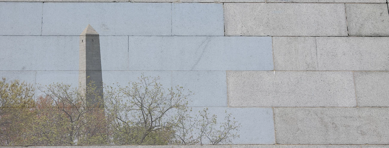 Banner for section 4 copy Photo of granite blocks, some of which are overlayed with a photo of the top half of the Bunker Hill Monument peaking out from trees.