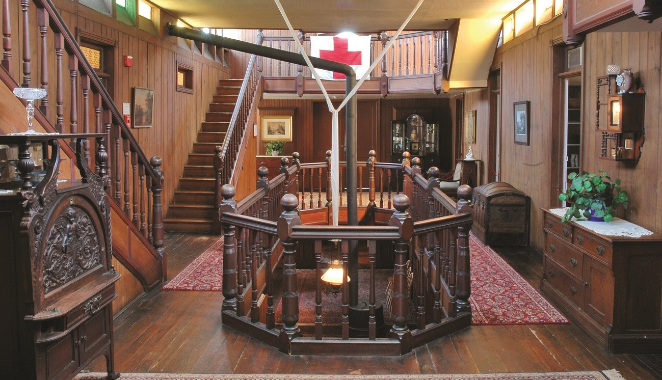 Interior of a historic home with a prominent interior balcony