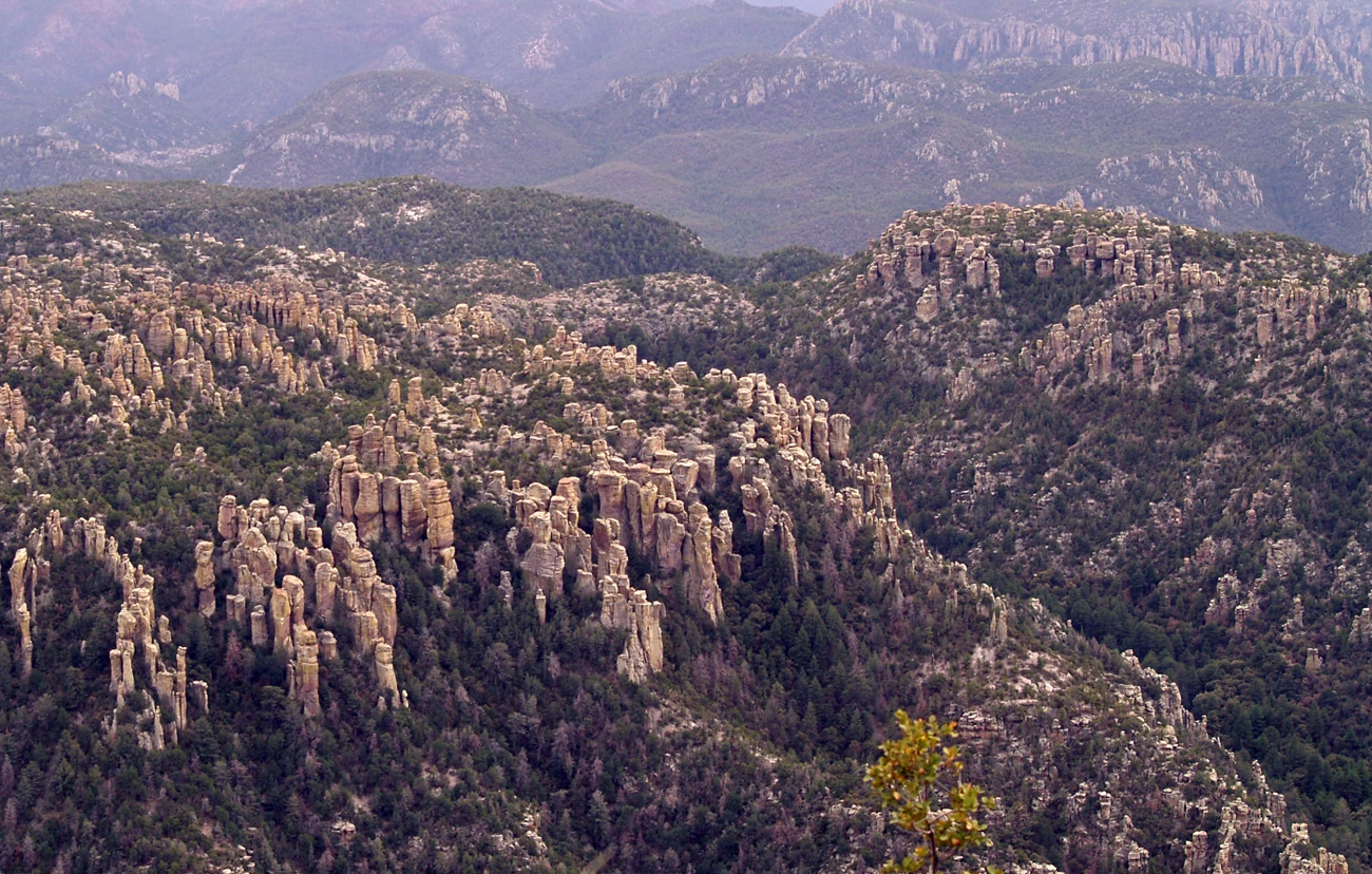 Cover chir_gri_rpt_body_print edited photo of a rolling landscape covered with trees and tall rock spires