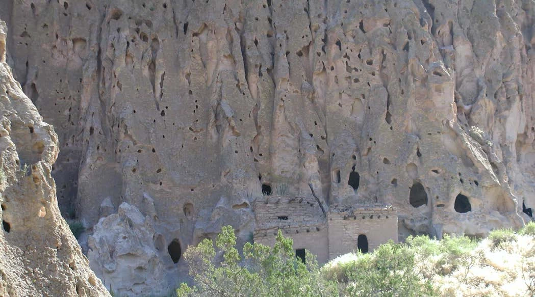Fig 3 band_gri_rpt_view Photo of cliff with carved windows and doors.