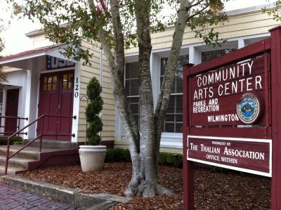 Hannah Block Historic USO/Community Arts Center today. Front entrance of the Hannah Block Historic USO/Community Arts Center. There is a sign naming the building, a tree next to the sign, and a potted plant next to the entrance stairs.