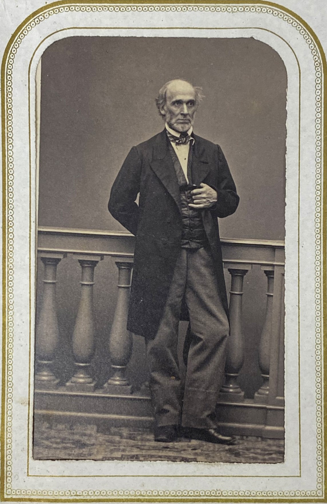 Hiram Powers historic black and white photo of a tall, slender man in a long suit jacket, with gold colored frame