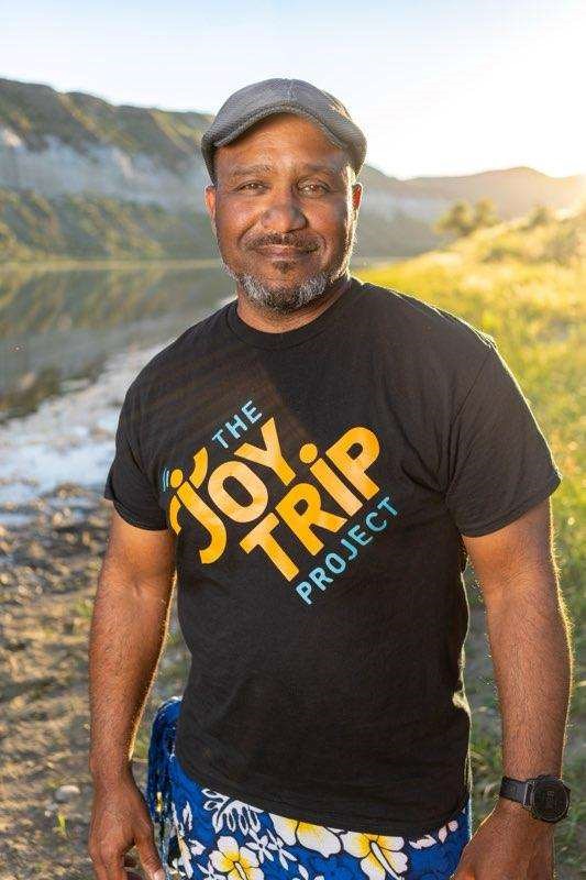 a black man wearing a gray cap