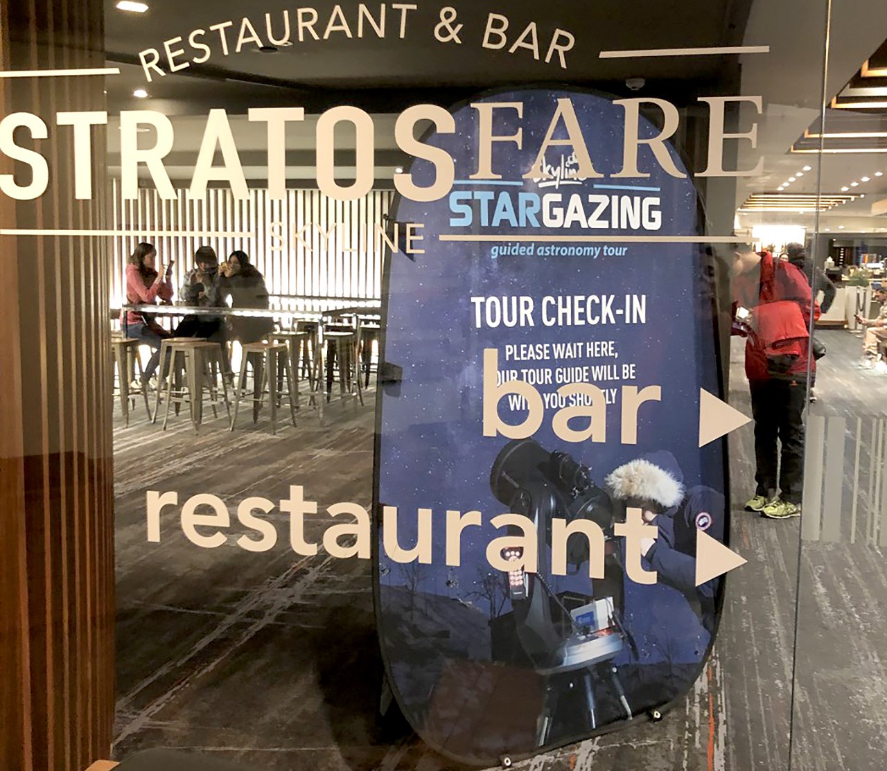 New Zealand stargazing ad seen through the glass window of a restaurant