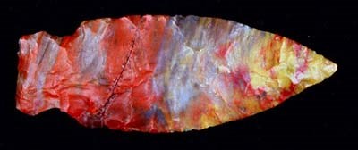 Arrowhead A brightly colored flaked and narrow arrowhead in bright colors of reds, blues, yellows and oranges.