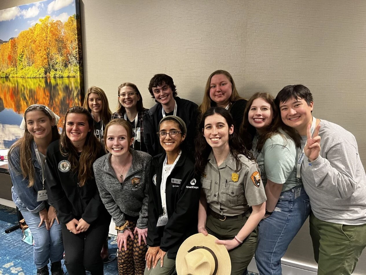 Ranger with community volunteer ambassadors A diverse group of young people with a park ranger in uniform