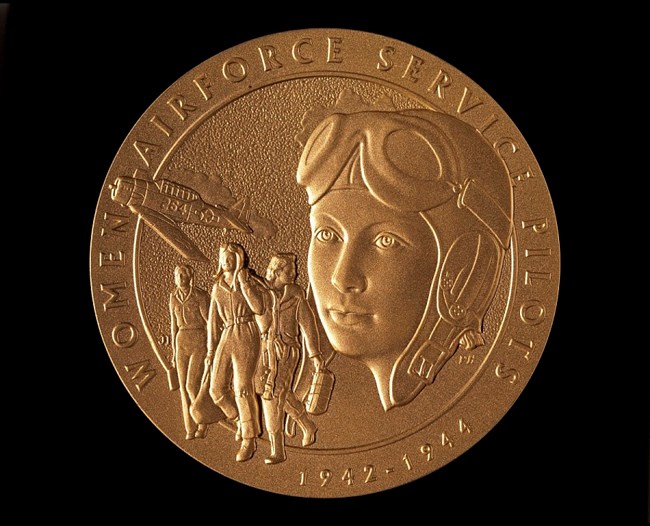 Congressional Gold Medal, WASP Close-up image of a cast medal with images of women pilots and the text Women's Airforce Service Pilots around the edge