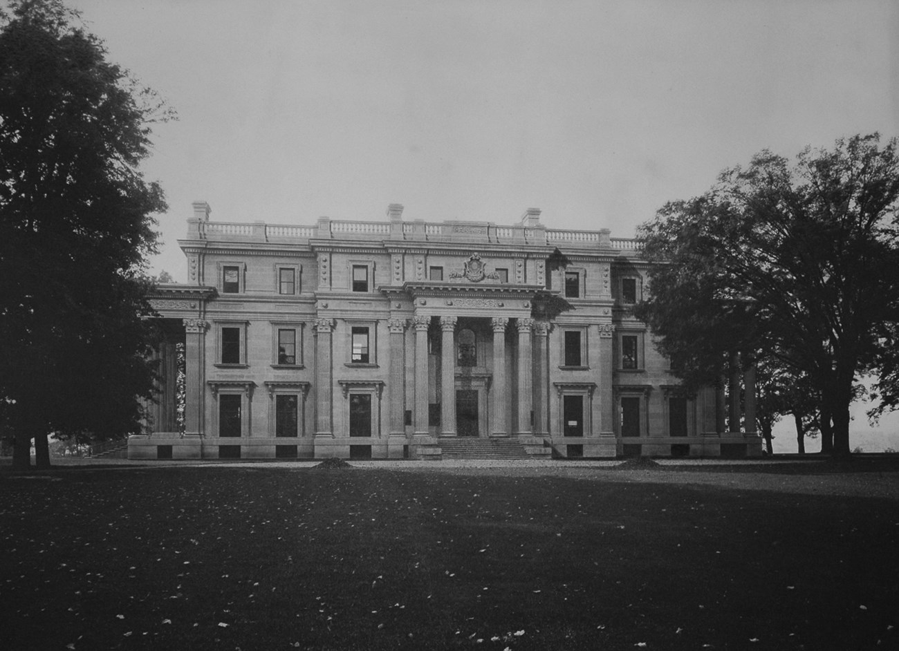 A large mansion on a vast lawn.