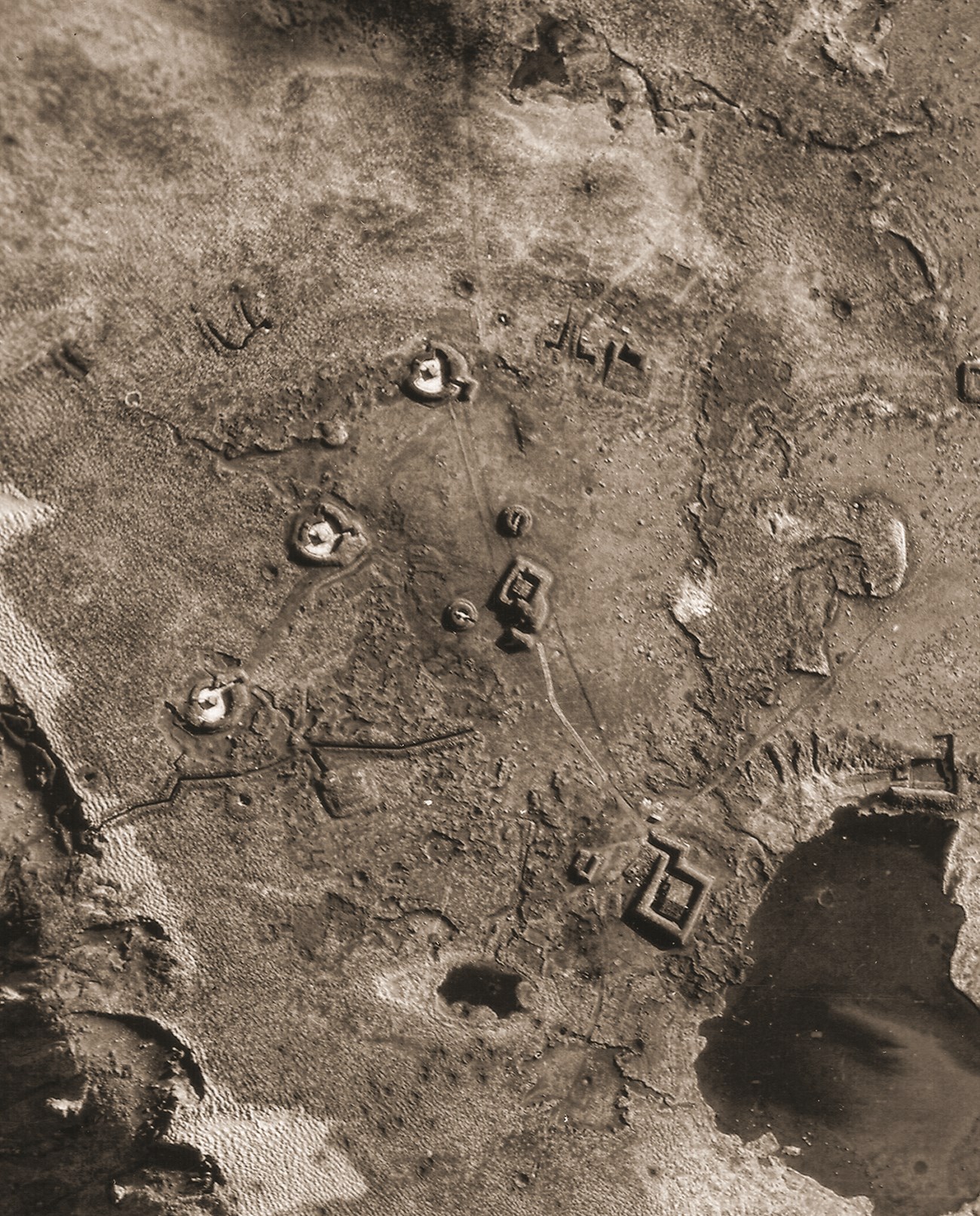 black and white photo of land with earthworks on it.