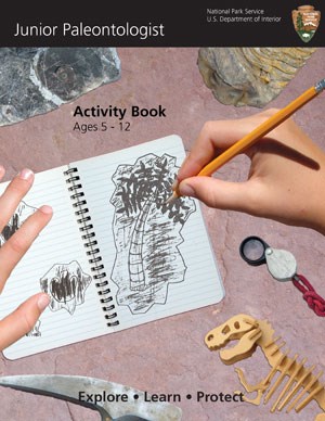 Junior Paleontologist Booklet Cover An image showing an open notebook and two hands drawing a fossil with a pencil