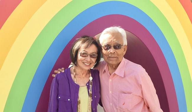 tom and ruth An elderly couple under a rainbow arch