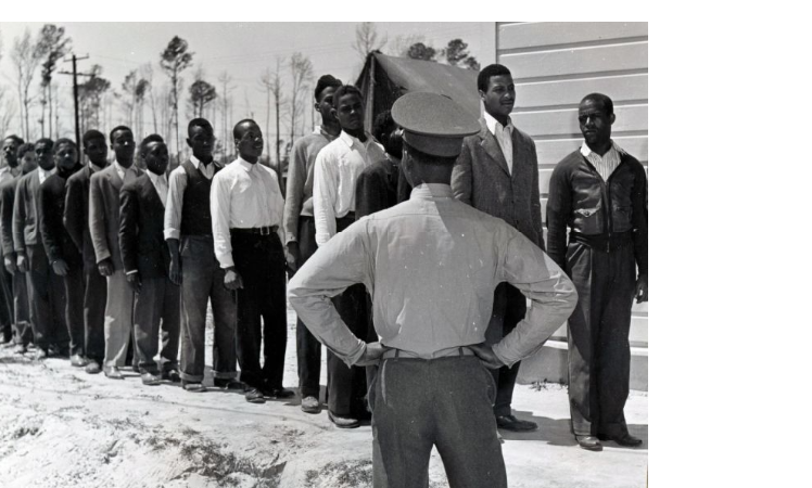 Lineup of new recruits for the Marines at Montford Point, 1943. The officer is facing away looking at the line up of new recruits