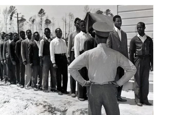 Lineup of new recruits for the Marines at Montford Point, 1943. Lineup of new recruits for the Marines at Montford Point, 1943. The officer is facing away looking at the line up of new recruits