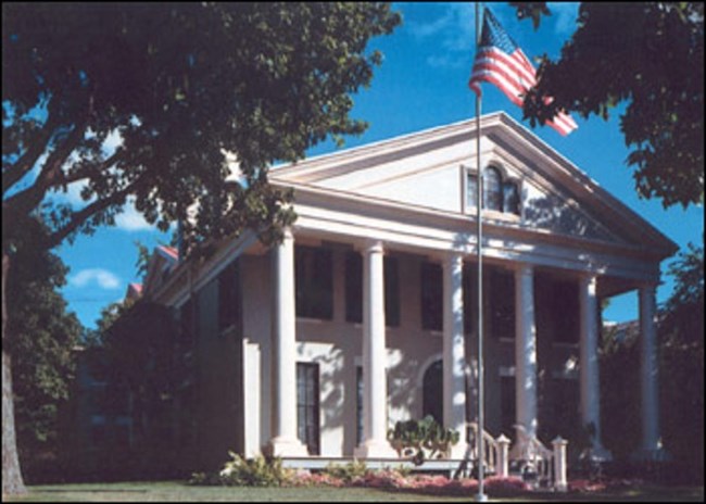 Exterior of white building with columns. Exterior of white building with columns.