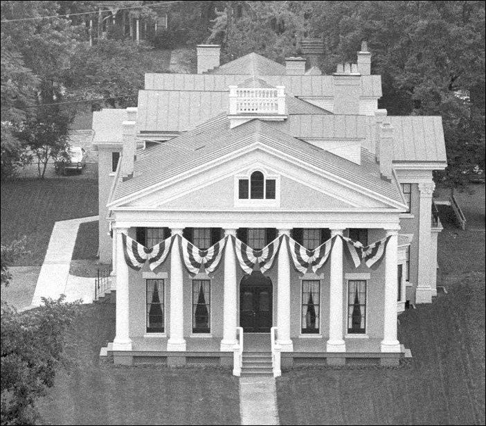 Aerial of large house with columns. Aerial of large house with columns.