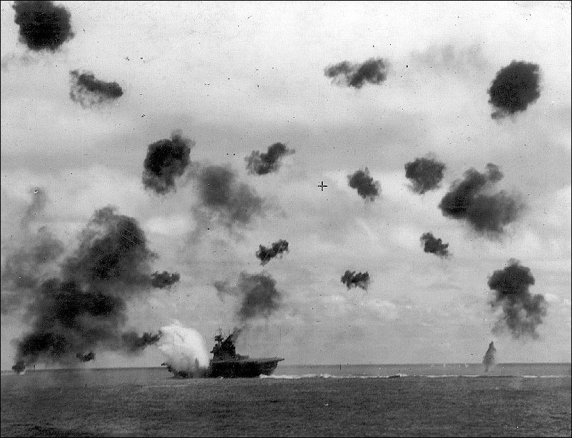 Bombs exploding over a carrier ship. Bombs exploding over a carrier ship.