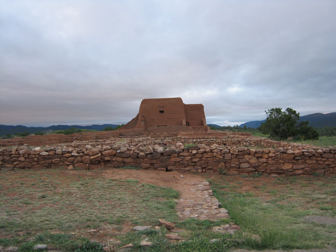 rock wall and adobe ruins