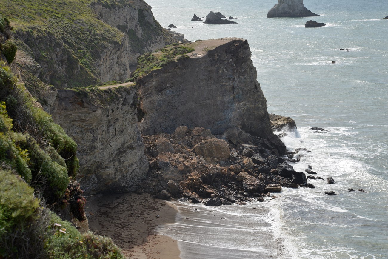 rock fall deposit on narrow beach