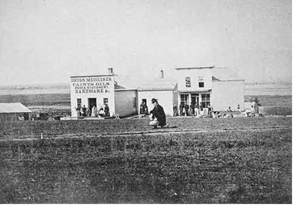 Small buildings in a field.