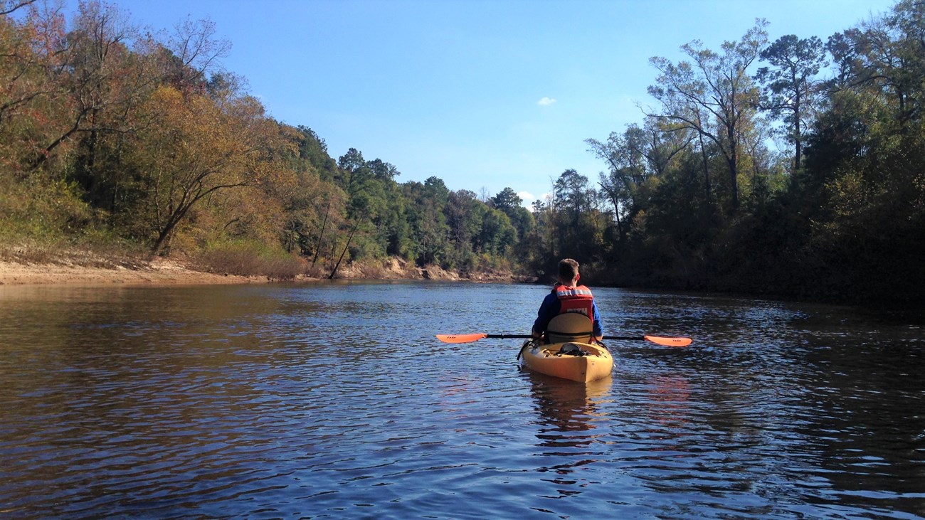 man in kayak on the river in the fall