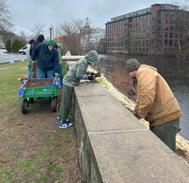 Scouts working Group of Scouts and Park staff work along riverbank