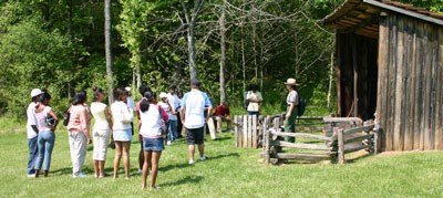 Park Ranger with tour group at Blacksmith Shed.