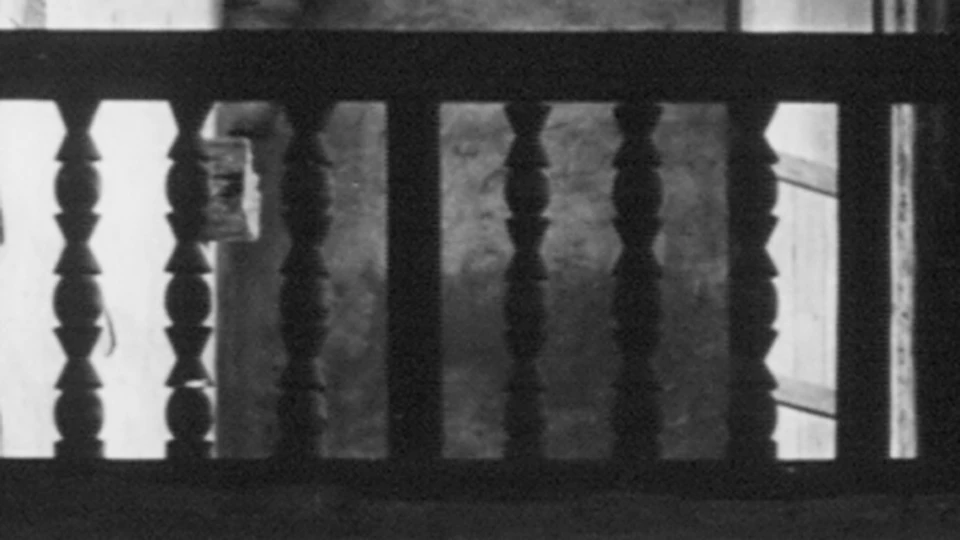 close up of carved wooden spindles on railing