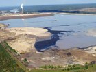 aerial view of a pond surrounded by dirt roads and machinery