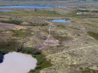aerial image of mining operations and pipes leading to ponds
