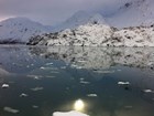snowy mountains surrounding an ice-filled bay