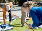 A woman breaks down a tent