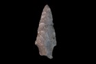 Projectile point shown with some chipped and refinished edges.