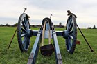 A view of the fort wall as seen over the back of a six-pound, field-piece cannon. 