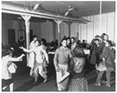 African American teenagers dance inside a building.