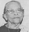 Black and white photo of woman in cat-eye glasses