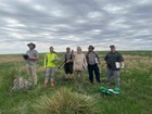 six men standing in a field