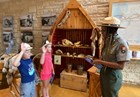a woman swears two children in as junior rangers