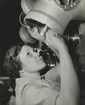 Black and white photo fo a woman working on a metal cylinder 