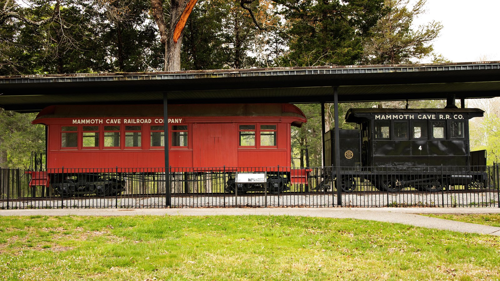 two train engines, one painted red and one painted black