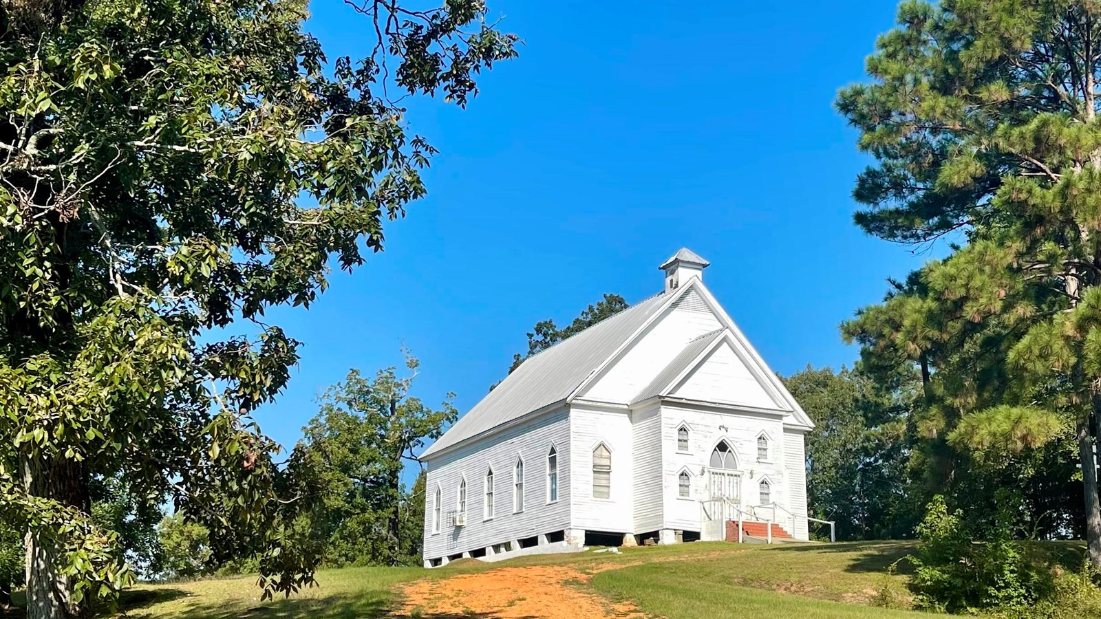 A small white church on a hilltop.