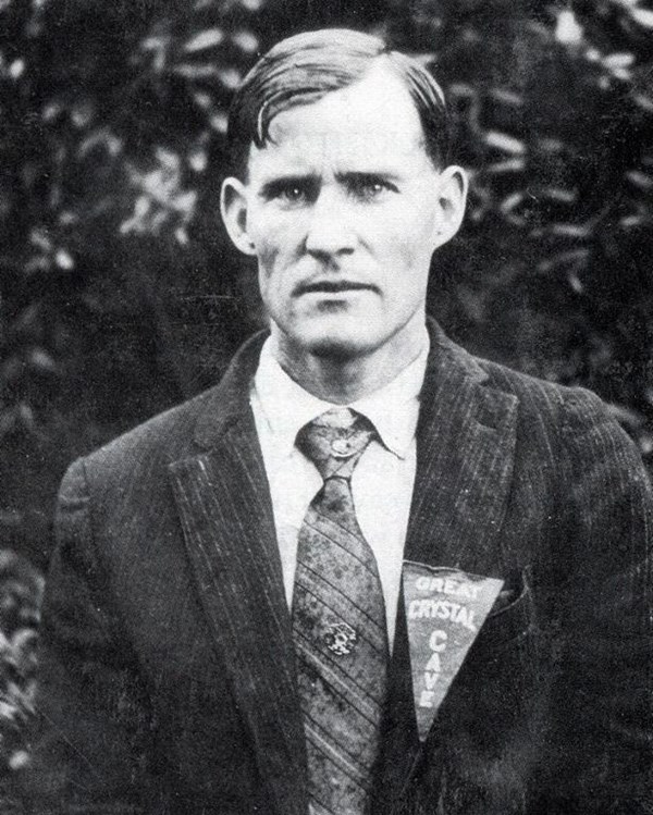 A black and white portrait of a man with wearing a suit