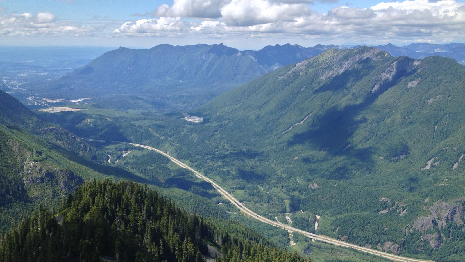 sweeping view of the green colored mountains and valleys 