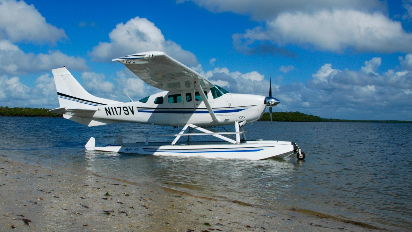 Seaplane with Isle Royale Seaplanes company sits on the water in a cove at Isle Royale National Park